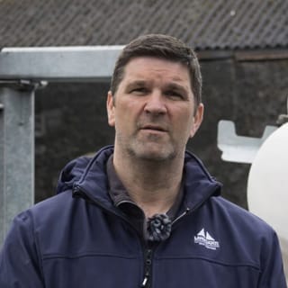 Dairy Farmer Rob Davies, standing in front of Tow and Fert 2800